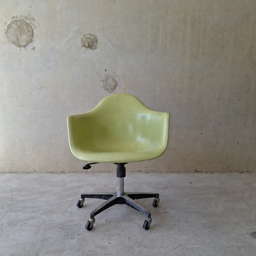 Modernica "Case Study" fibreglass shell rolling armchair.