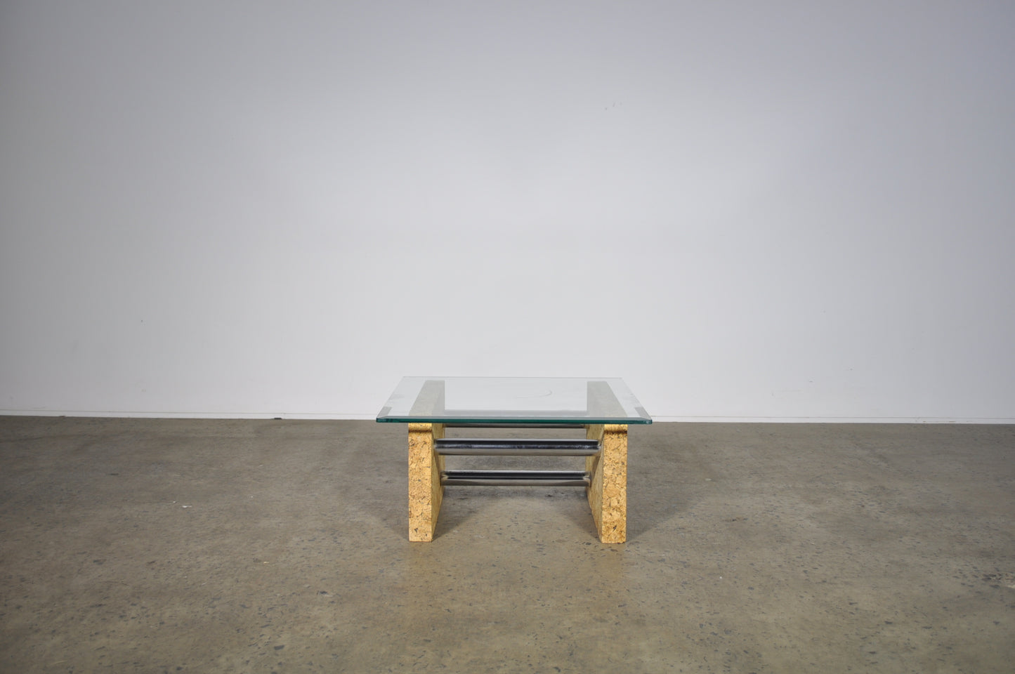 Brutalist glass coffee table with cork base.