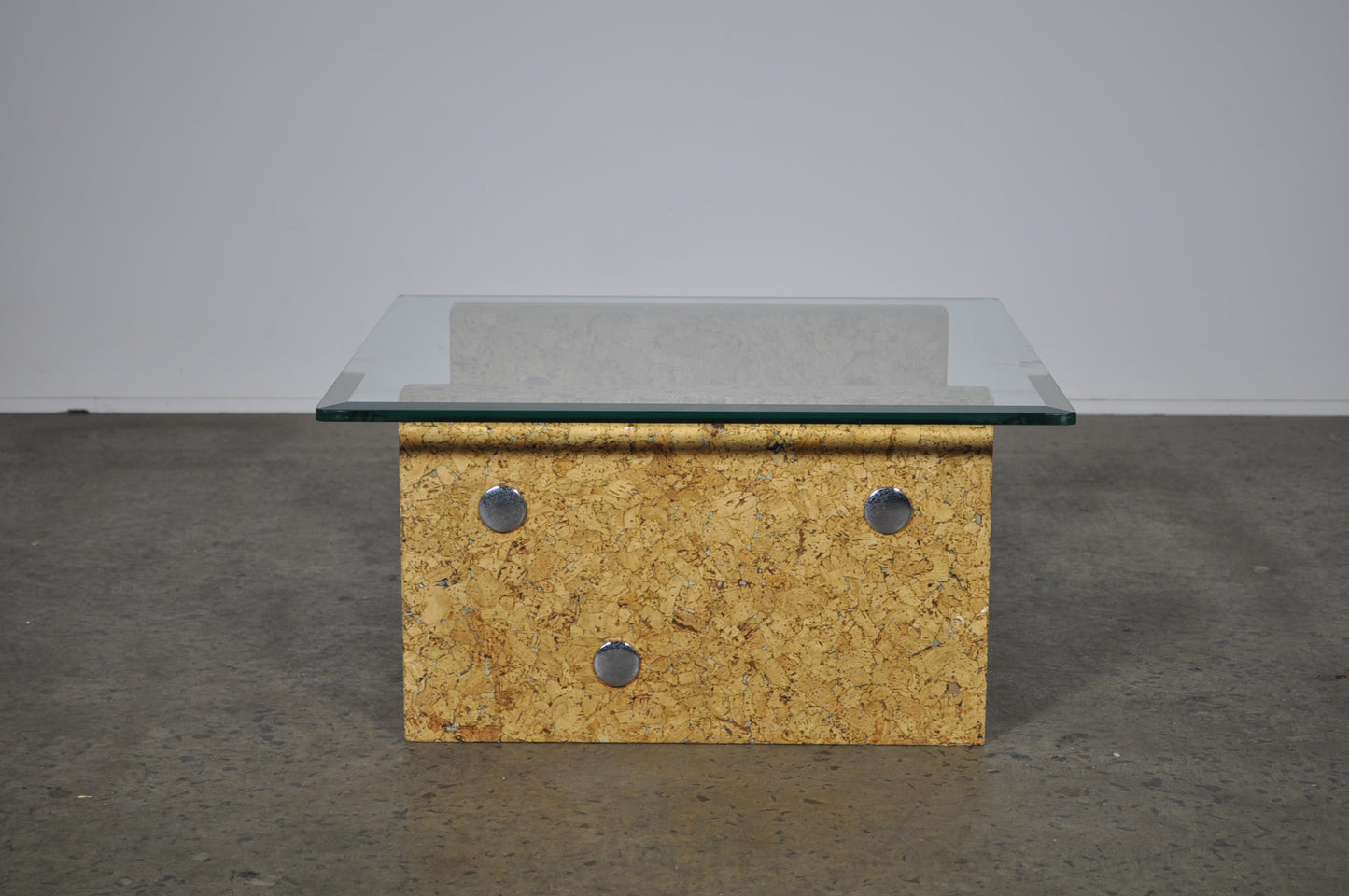 Brutalist glass coffee table with cork base.