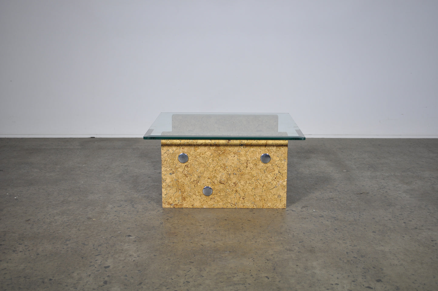 Brutalist glass coffee table with cork base.