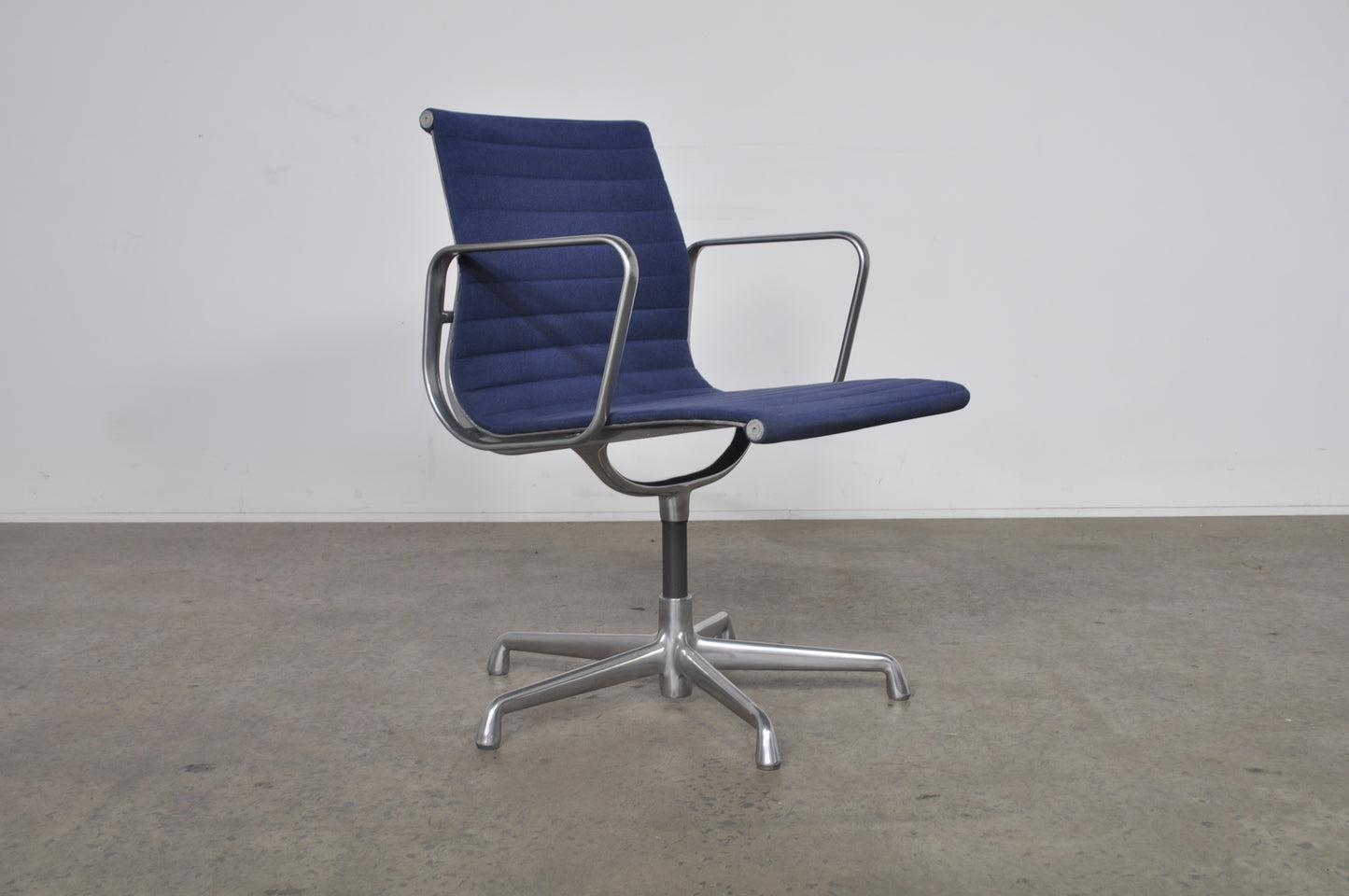 Eames Aluminium Group side chair with arms.