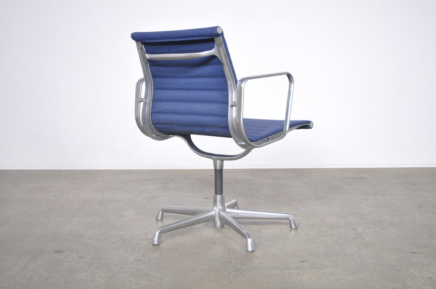 Eames Aluminium Group side chair with arms.