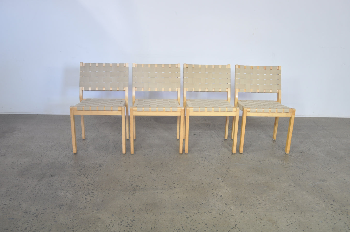 Alvar Aalto dining chairs by Artek in natural Danish webbing.