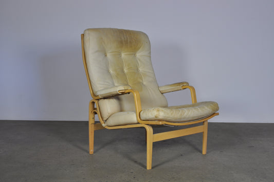 Bruno Mathsson in white leather Ingrid armchair.