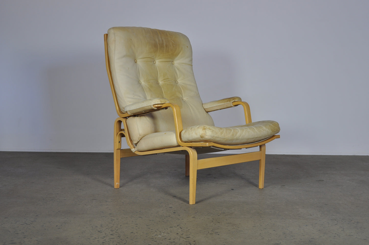 Bruno Mathsson in white leather Ingrid armchair.