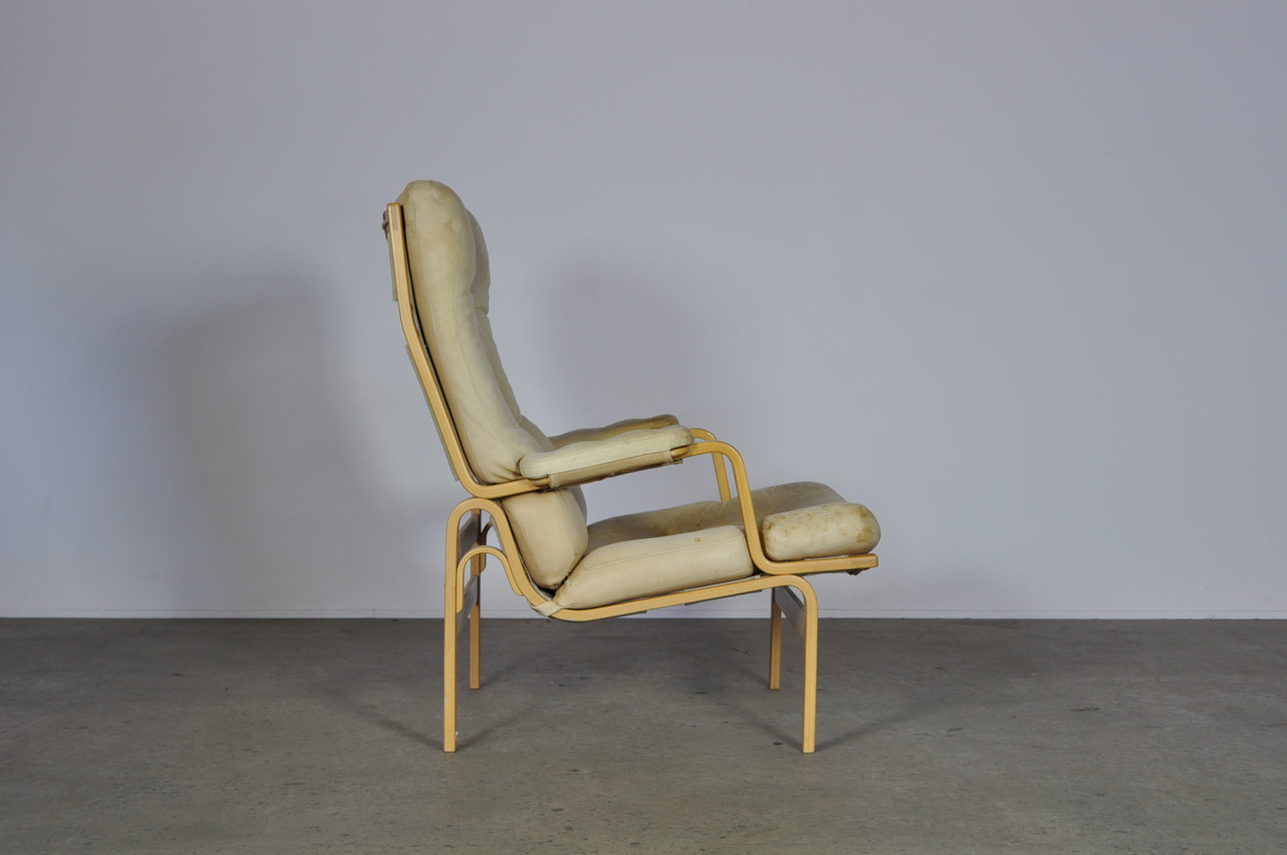 Bruno Mathsson in white leather Ingrid armchair.