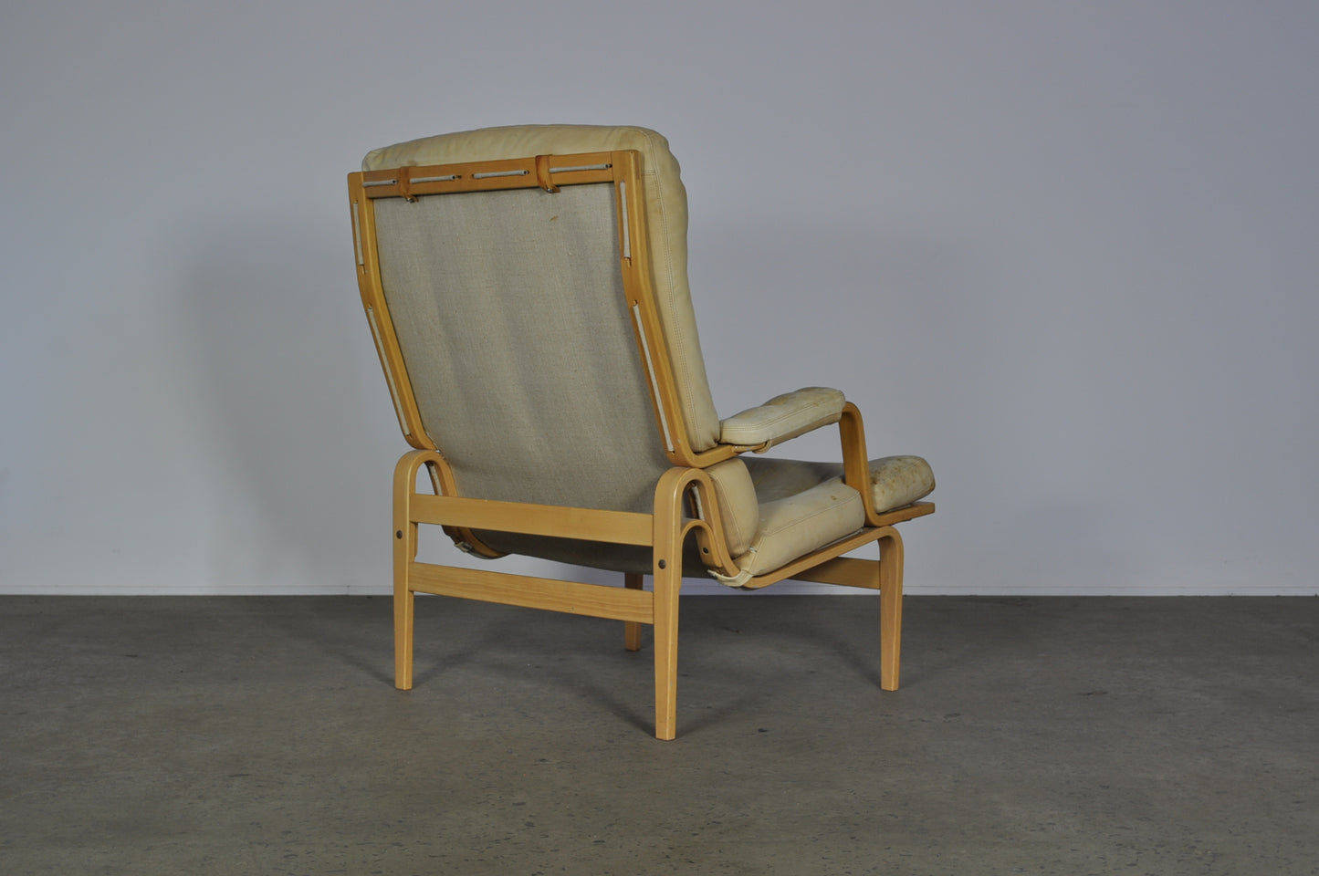 Bruno Mathsson in white leather Ingrid armchair.