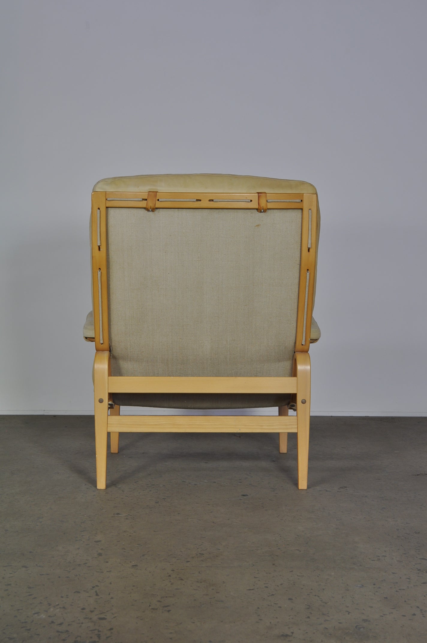 Bruno Mathsson in white leather Ingrid armchair.