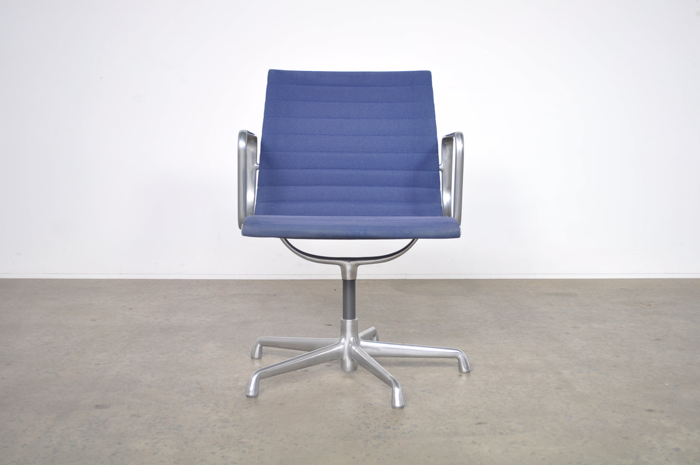 Eames Aluminium Group side chair with arms.