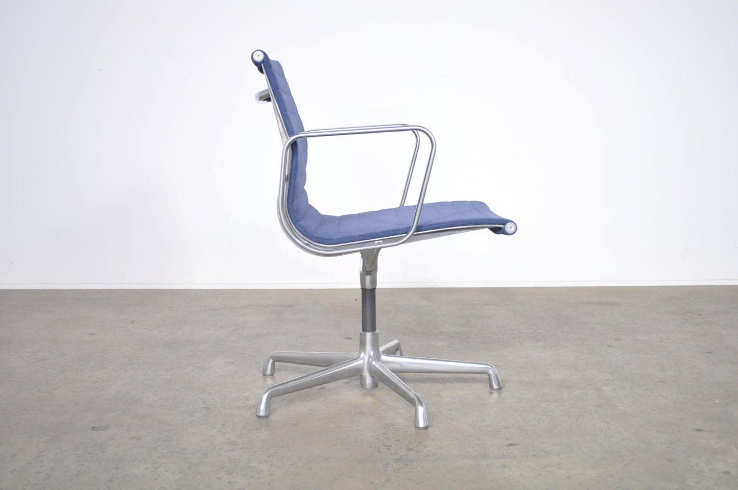 Eames Aluminium Group side chair with arms.