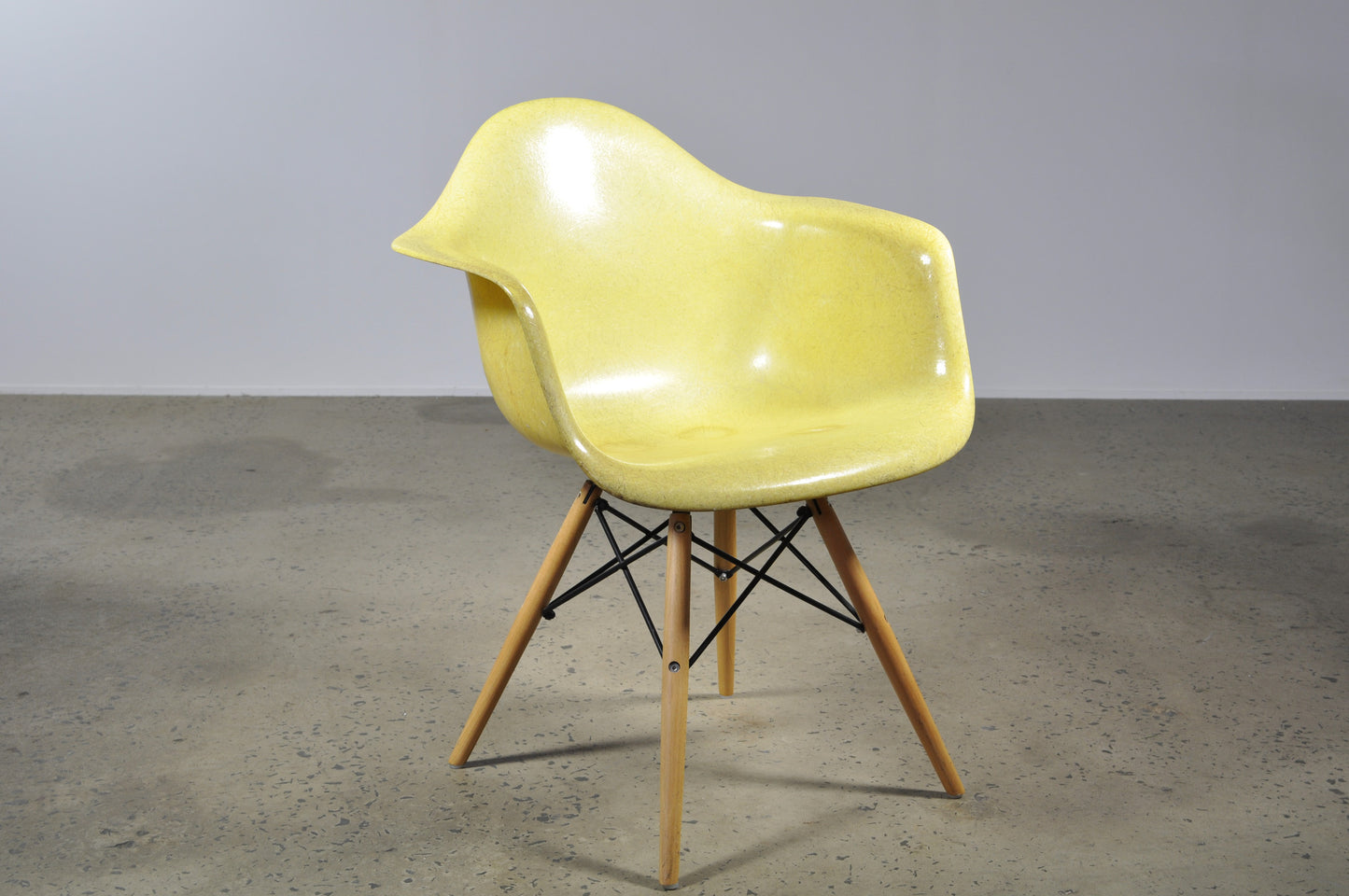Eames fibre glass lounge style shell on a wooden dining chair base.